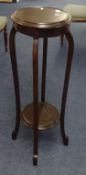 A early 20th century circular plants stand with 2 tiers and mahogany finished