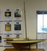 A model sail yacht and stand.