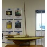 A model sail yacht and stand.