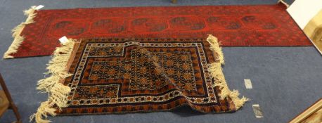 An Eastern floor runner, approx. 300cm long, and a small rug (2).