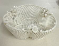 A circular Belleek basket, the rim applied with roses, 'Belleek' impressed on a strap, 16cm wide.