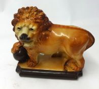 Staffordshire pottery model of a standing lion (lacks eyes).
