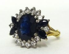 An 18ct gold large sapphire and diamond cluster ring, size O.