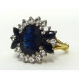 An 18ct gold large sapphire and diamond cluster ring, size O.