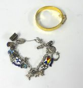 A gilt metal bangle and a silver charm bracelet (2).