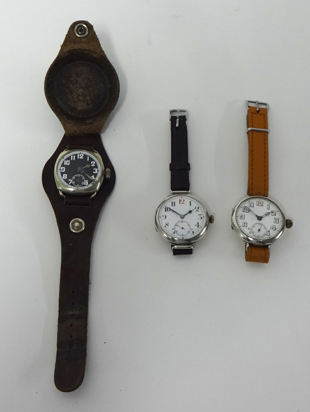 Two silver and one nickel military style traditional Gents wrist watches.