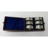 A set of six silver napkin rings in fitted case, weight 62.60g.