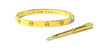 CARTIER a 18ct yellow gold love bangle with associated screwdriver, engraved to the inside 19,750,