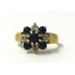 A small sapphire cluster ring, unmarked, size M.