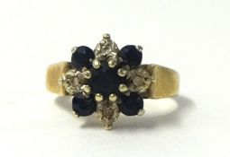 A small sapphire cluster ring, unmarked, size M.