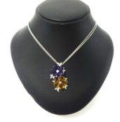 A pretty 18ct white gold citrine and amethyst diamond set pendant and white gold chain.