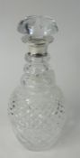 A cut glass decanter with silver neck and stopper, height 28cm.