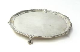 A Victorian silver waiter by C. Stuart Harris, London 1889 of circular form with a bead border,