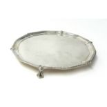 A Victorian silver waiter by C. Stuart Harris, London 1889 of circular form with a bead border,