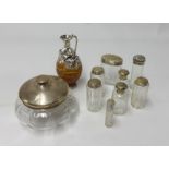 A collection of silver top and glass dressing table bottles (7) also a silver and glass powder