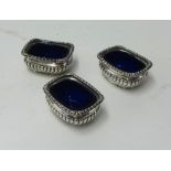 Three Victorian silver table salts with blue glass  liners, London 1896.