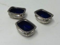 Three Victorian silver table salts with blue glass  liners, London 1896.