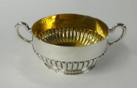 A Victorian silver porringer or sugar bowl, with twin handles, half fluted body, circa 1880,