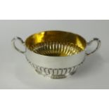 A Victorian silver porringer or sugar bowl, with twin handles, half fluted body, circa 1880,