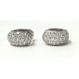 A pair of 18ct white gold and diamond ear clips, pave set with brilliant cut stones, total diamond