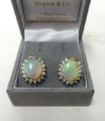 A fine pair of  18ct gold opal and diamond cluster earrings, similar design to lot 218 and lot 219.