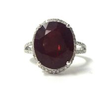 A 14k white gold and diamond ring set with an oval cut ruby, approx. 9ct, diamonds approx. 0.40ct