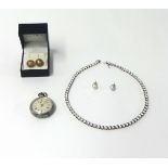 A silver and cubic zirconia line necklace, claw set with brilliant cut stones, a pair of cultured