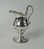 A 19th century silver cream jug, with high scroll handle, height 16cm, weight 5.50oz.