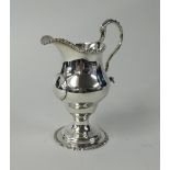 A 19th century silver cream jug, with high scroll handle, height 16cm, weight 5.50oz.