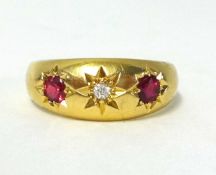 An antique 18ct gold ruby and diamond three stone ring.