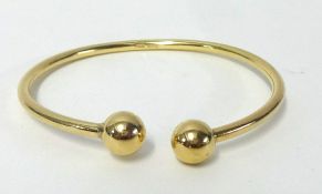 A 9ct gold 'slave' bangle, weight 18.70g.