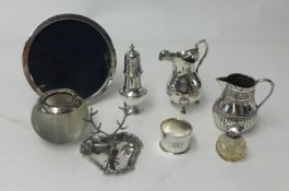 A collection of various silver ware including pepper pot, cream jug, stag, ring stand, circular