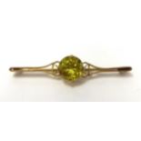 A 9ct pale peridot bar brooch, stamped .375.