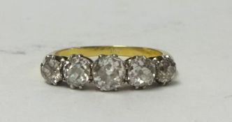 A diamond five stone half hoop ring, size P.