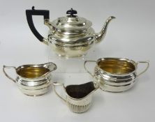 A pair of silver sugar tongs, silver plated wares including a three piece tea set, three wine bottle