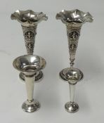 A pair of Eastern embossed white metal spill vases, weight 5.70oz, and two English silver small