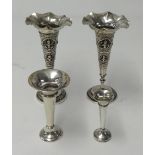 A pair of Eastern embossed white metal spill vases, weight 5.70oz, and two English silver small