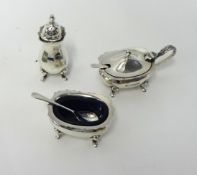 A modern silver three piece cruet set.