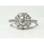 A diamond and platinum cluster ring, of good colour and clarity, the centre stone approx. 0.50