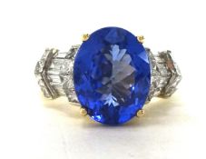 A tanzanite and diamond set 14ct. yellow gold ring , with a mix of baguettes, round and princess cut