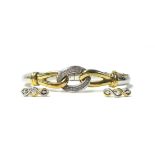 A 9ct gold, silver and diamond set hinged bangle, the two colour knot front set with single cut