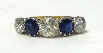 An 18ct five stone platinum diamond and sapphire ring. size L.