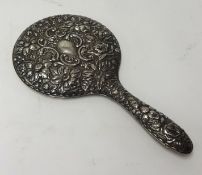 A Victorian silver back and embossed dressing table hand mirror.
