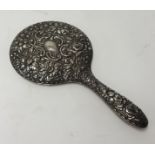 A Victorian silver back and embossed dressing table hand mirror.