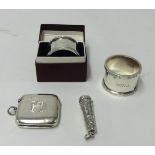 A pair of silver Mappin and Webb serviette rings (one boxed), silver vesta, silver needle case, (