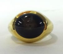 A gents 18ct gold signet ring set with a good star sapphire of  form, ring size P.