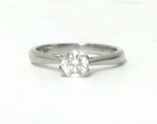 A platinum and diamond single stone ring, claw set with a brilliant cut stone weighing 0.44cts,