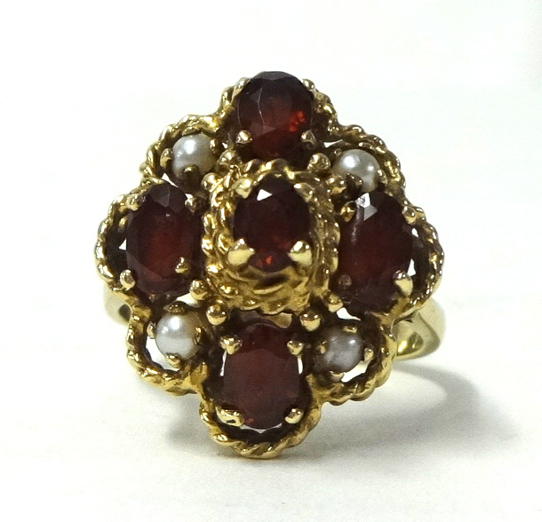 A large 9ct gold garnet and pearl ring, size T.