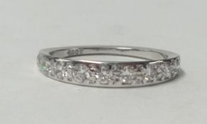 An 18ct diamond half band eternity ring, size L.