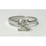 A white metal and single stone diamond ring, claw set with a brilliant cut stone of approximately